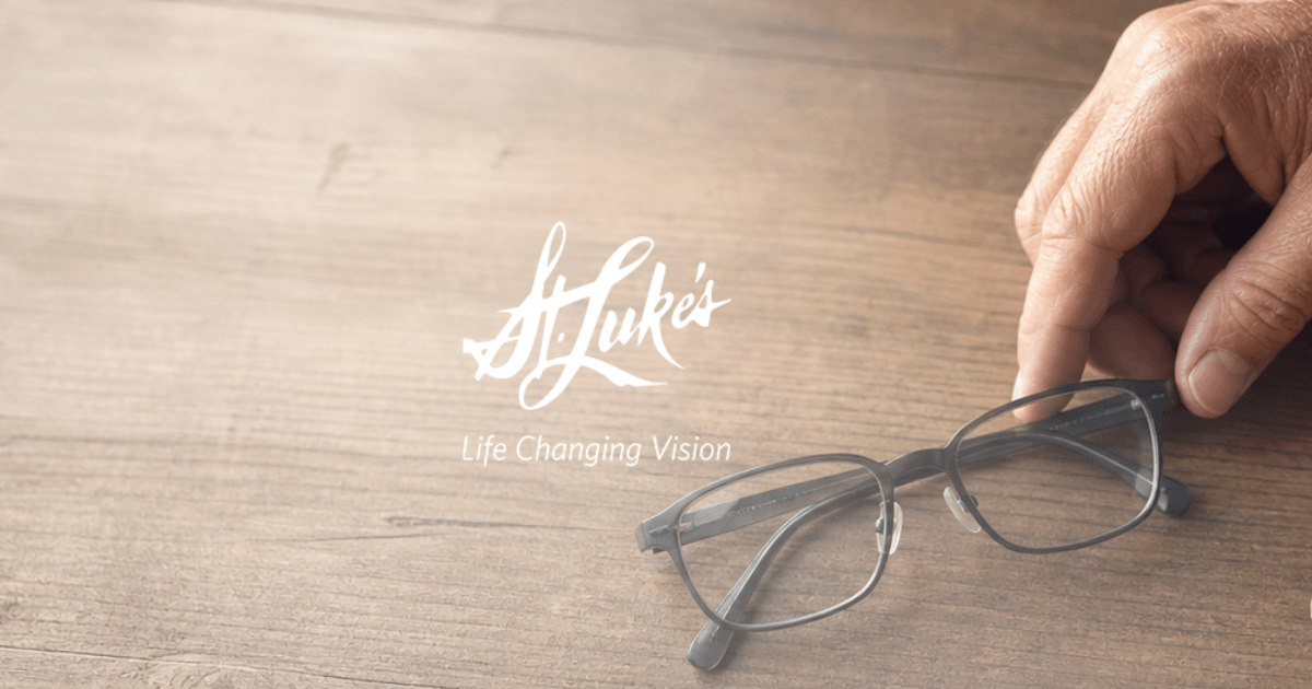 Overhead angle of hands setting down glasses for LASIK recovery banner Image - Decorative